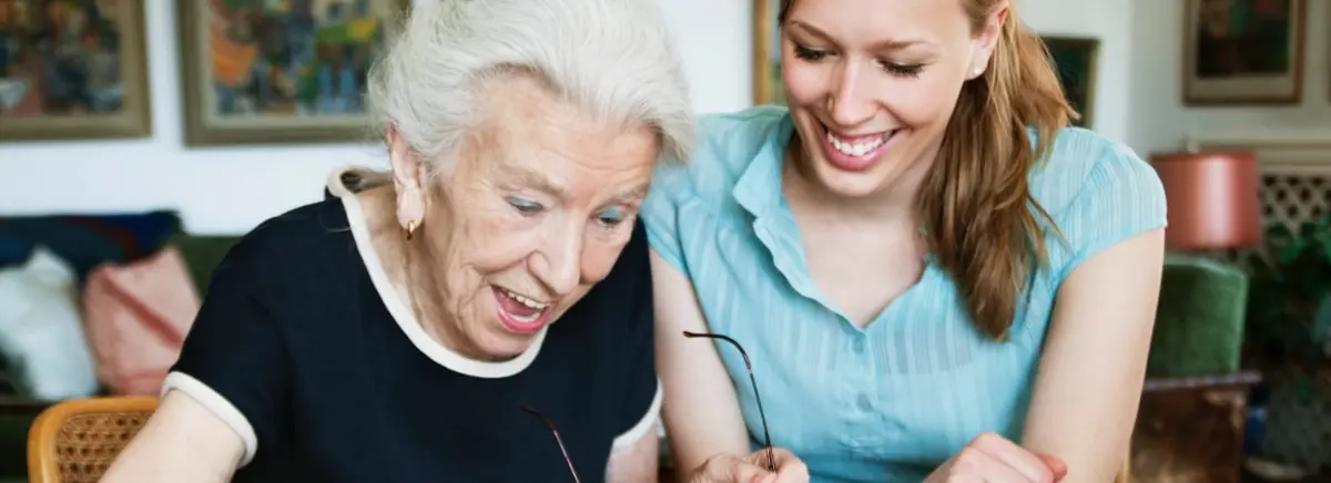 A SYNERGY HomeCare caregiver helping a senior with daily care and companionship